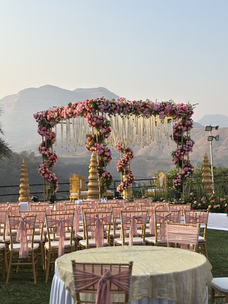 Outdoor floral mandap wedding ceremony with mountain views